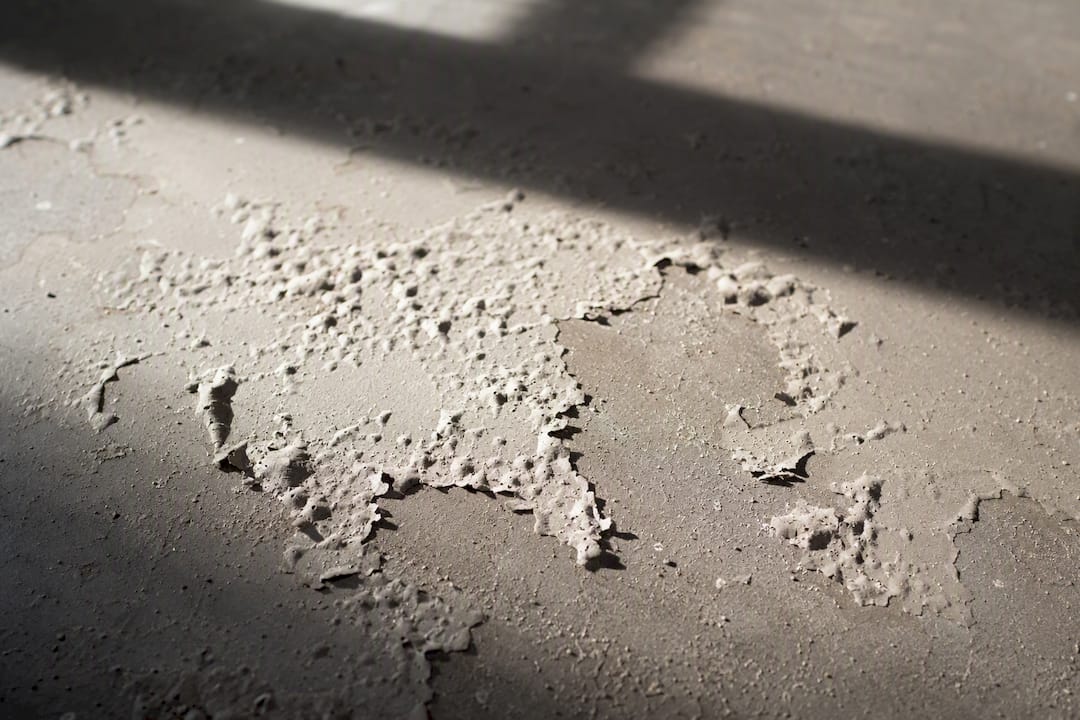 Paint blistering damage on cement screed floor