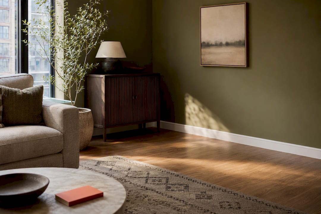 Olive wall coordinated with warm wood flooring